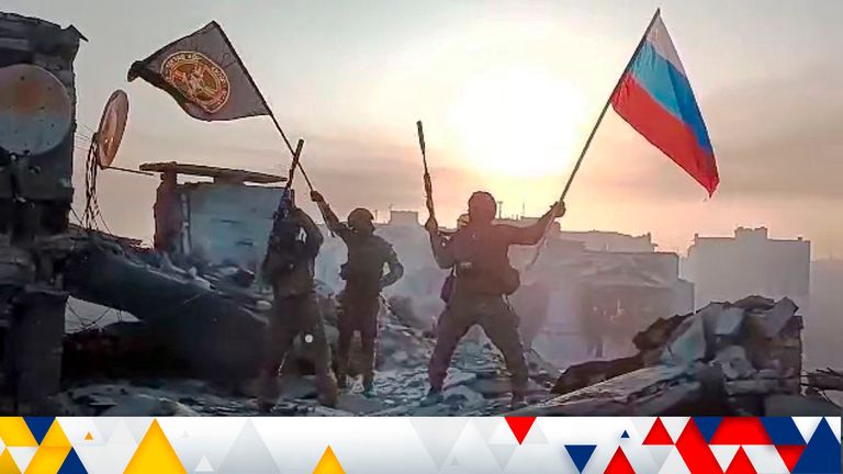  Yevgeny Prigozhin&#39;s Wagner Group military company members wave a Russian national and Wagner flag atop a damaged building in Bakhmut, Ukraine 
Pic:Prigozhin Press Service /AP