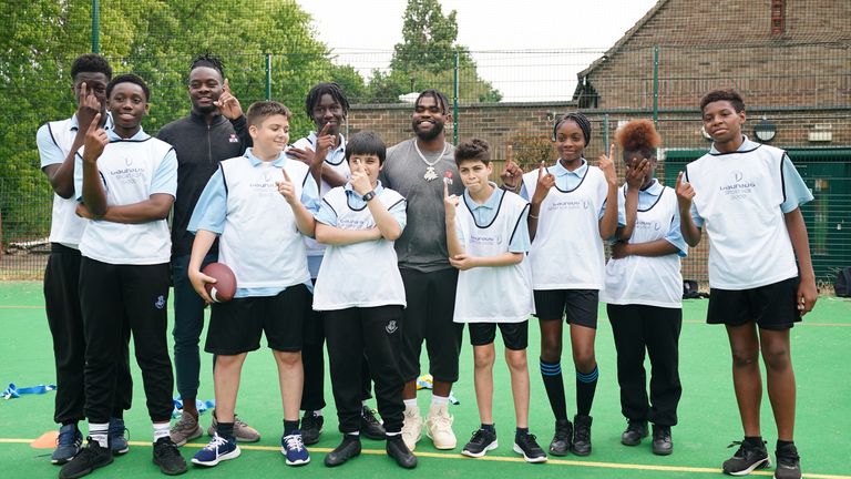 Michael Gallup and Clyde Edwards-Helaire pictured with school kids at Gladesmore Community School
